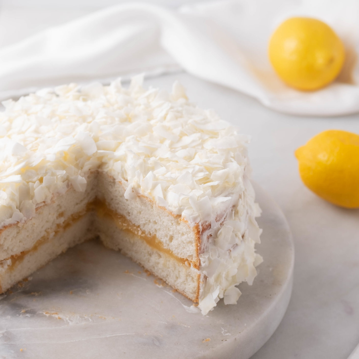 coconut cake out of a boxed cake mix sliced with lemons